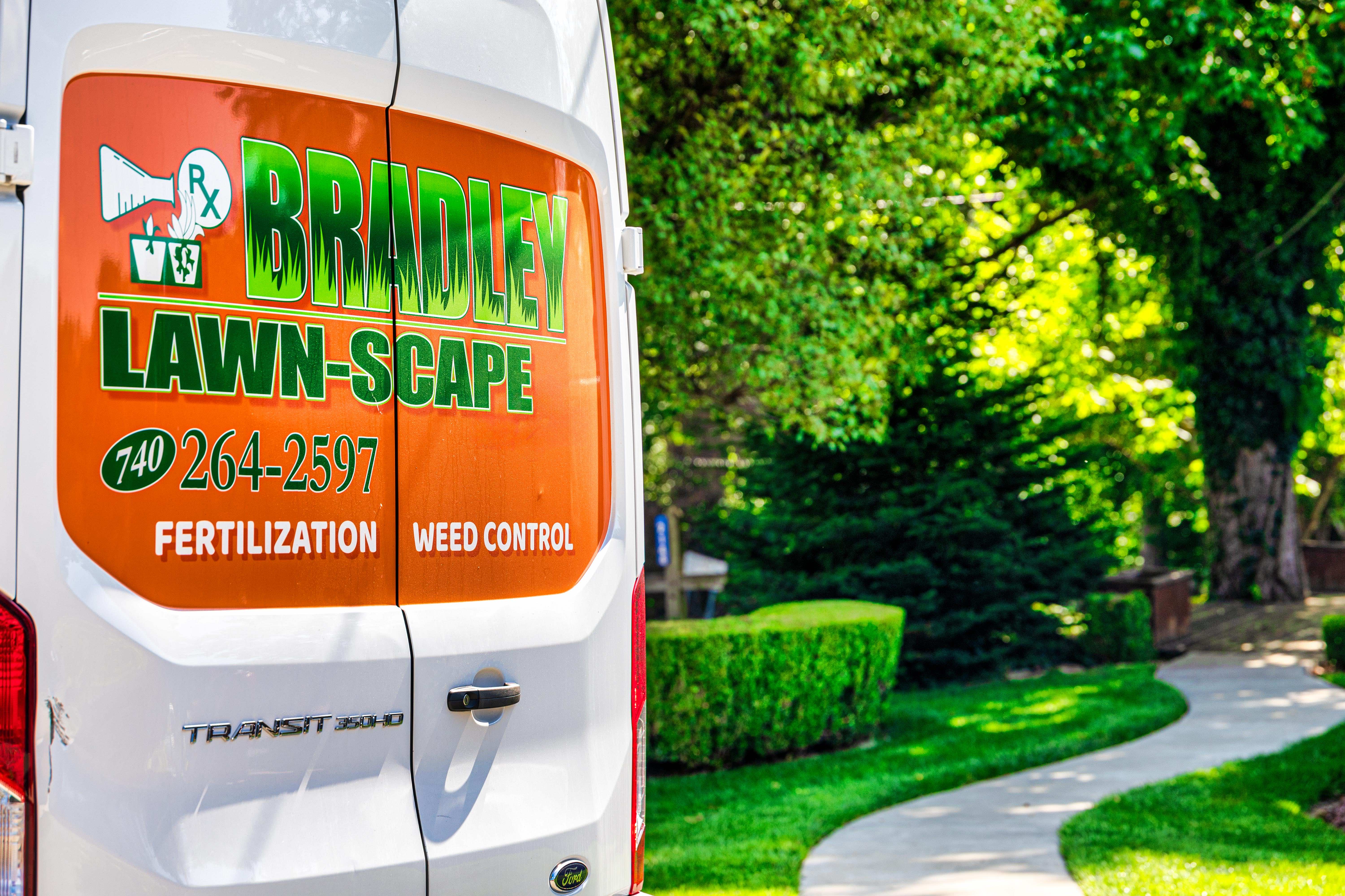 Orange and green Bradley Lawn-Scape wrap on a Ford Transit